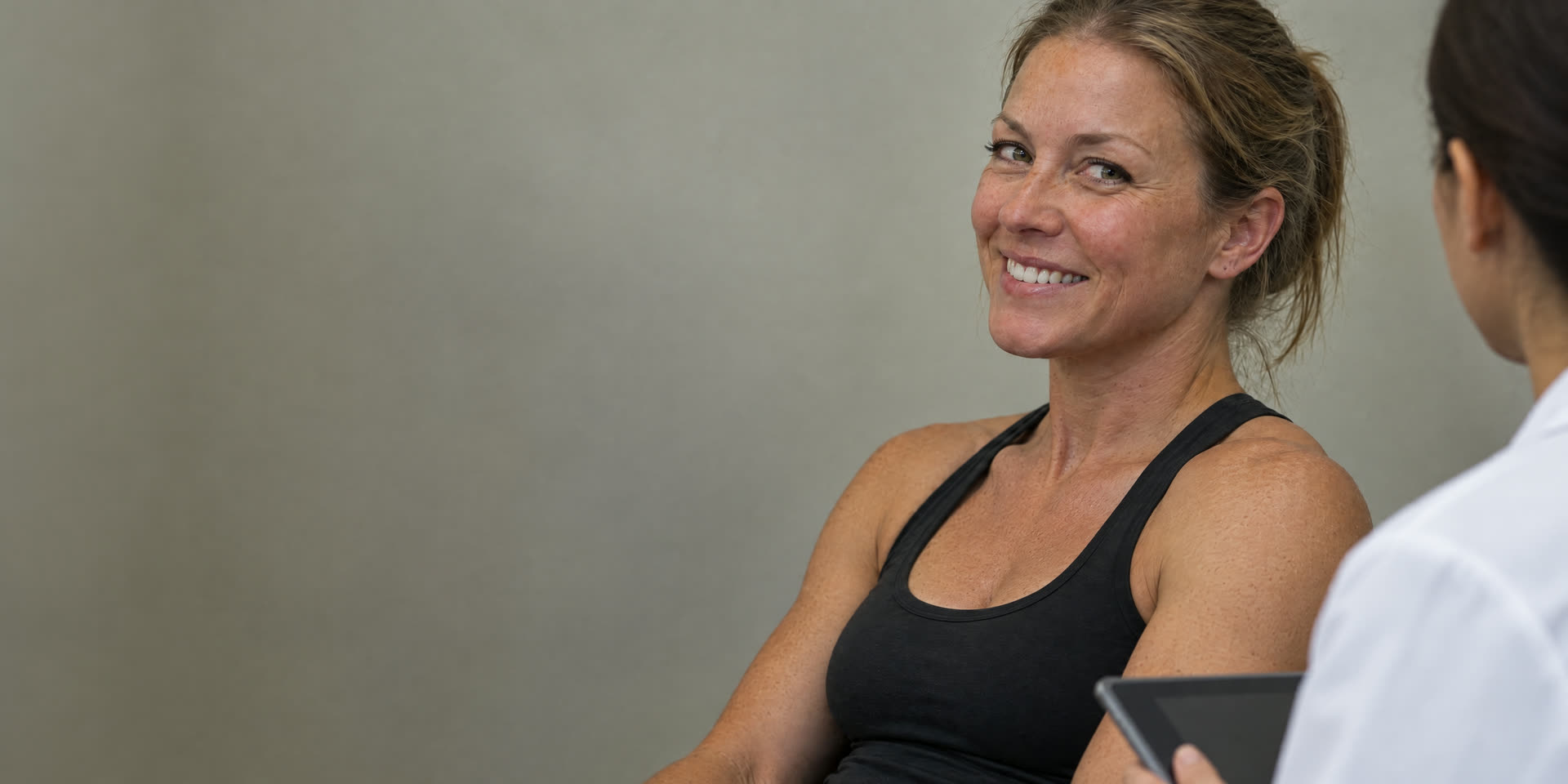A smiling patient seated in the draw chair at Med Matrix before her blood draw